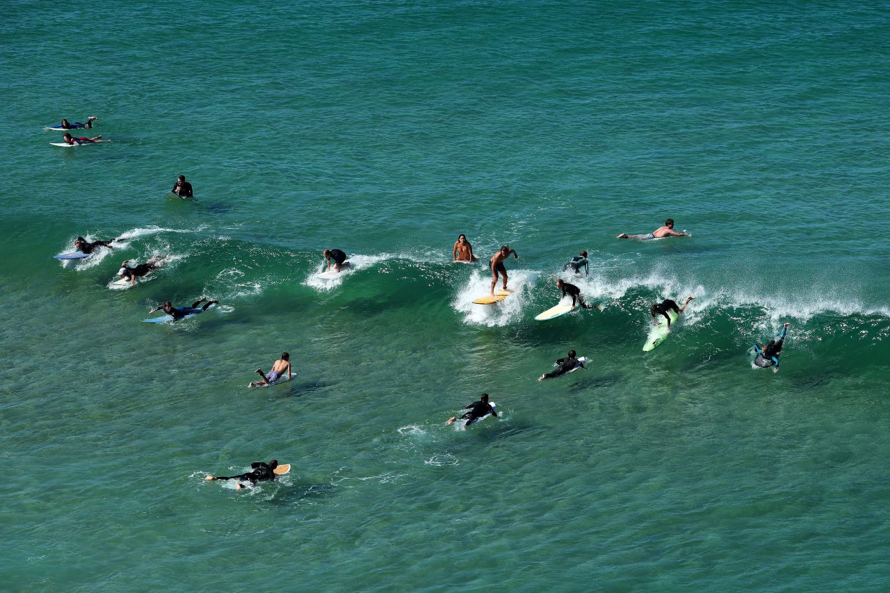 Surfers ride waves at Freshwater Beach in Sydney on on April 5.