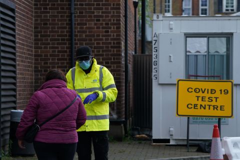 A NHS employee speaks to a member of the public outside a Covid-19 testing center in Dalston, east London, on September 23.