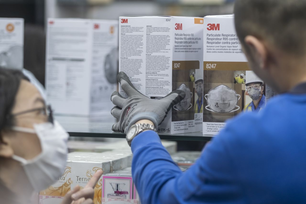 An employee arranges boxes of 3M Co. 8247 R95 particulate respirators at a pharmacy in the Central district of Hong Kong on Thursday