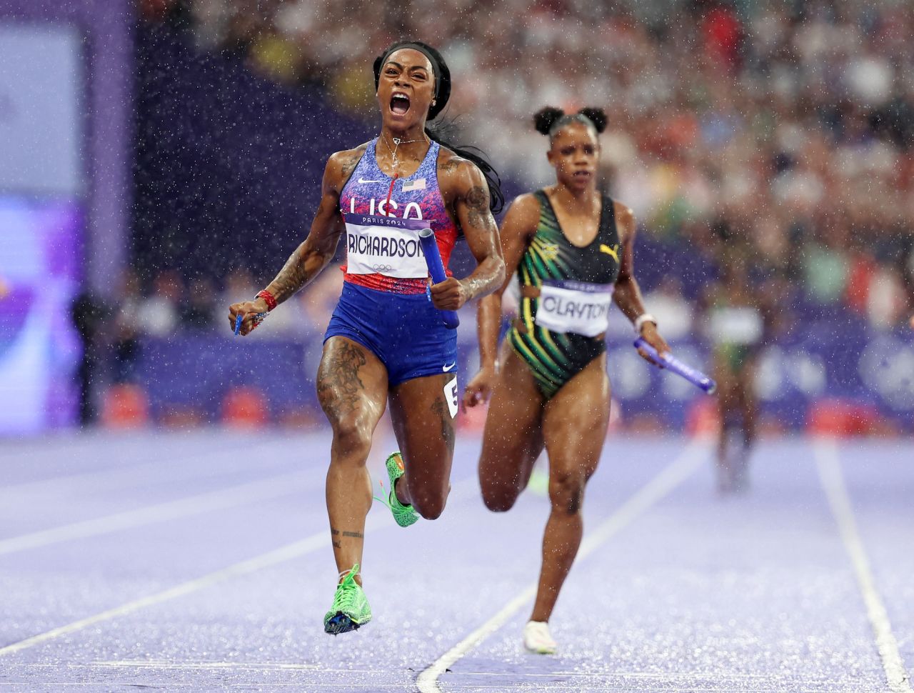 Sha'Carri Richardson crosses the finish line to win gold in the women's 4x100m relay final.