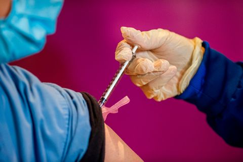 A health care worker receives the second dose of the Pfizer/BioNTech vaccine at the Hartford Convention Center in Hartford, Connecticut, on Monday, January 4.