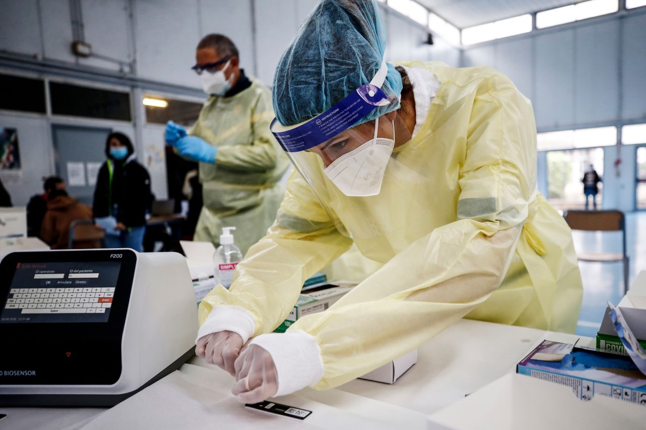 Medical staff perform rapid COVID-19 tests at a high school in Rome on September 28.