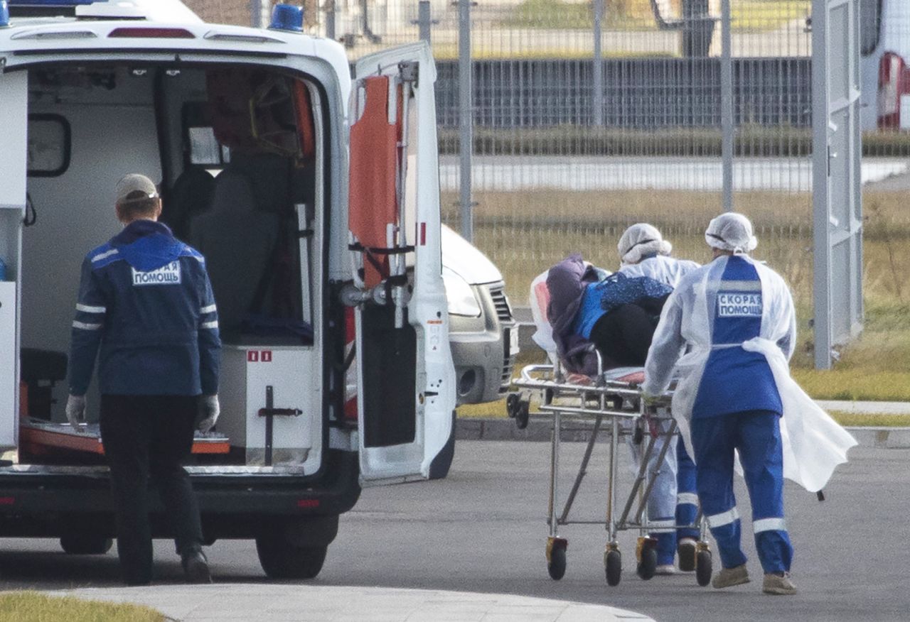 Medical workers carry a suspected coronavirus patient at a hospital in Kommunarka, Russia, on Thursday, October 15. 