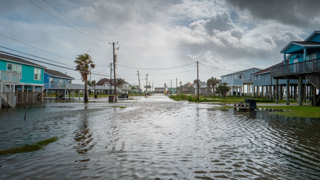 Floodwater flows through a neighborhood on June 20, in Jamaica Beach, Texas. 