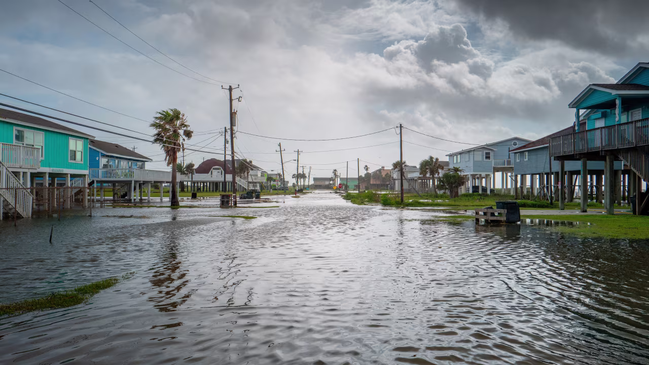 Floodwater flows through a neighborhood on June 20, in Jamaica Beach, Texas. 
