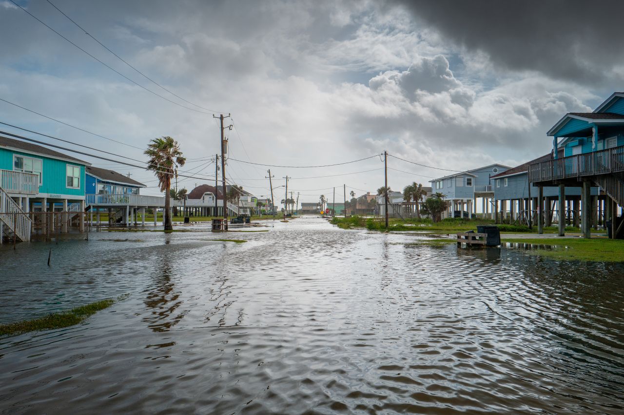 Floodwater flows through a neighborhood on June 20, in Jamaica Beach, Texas. 