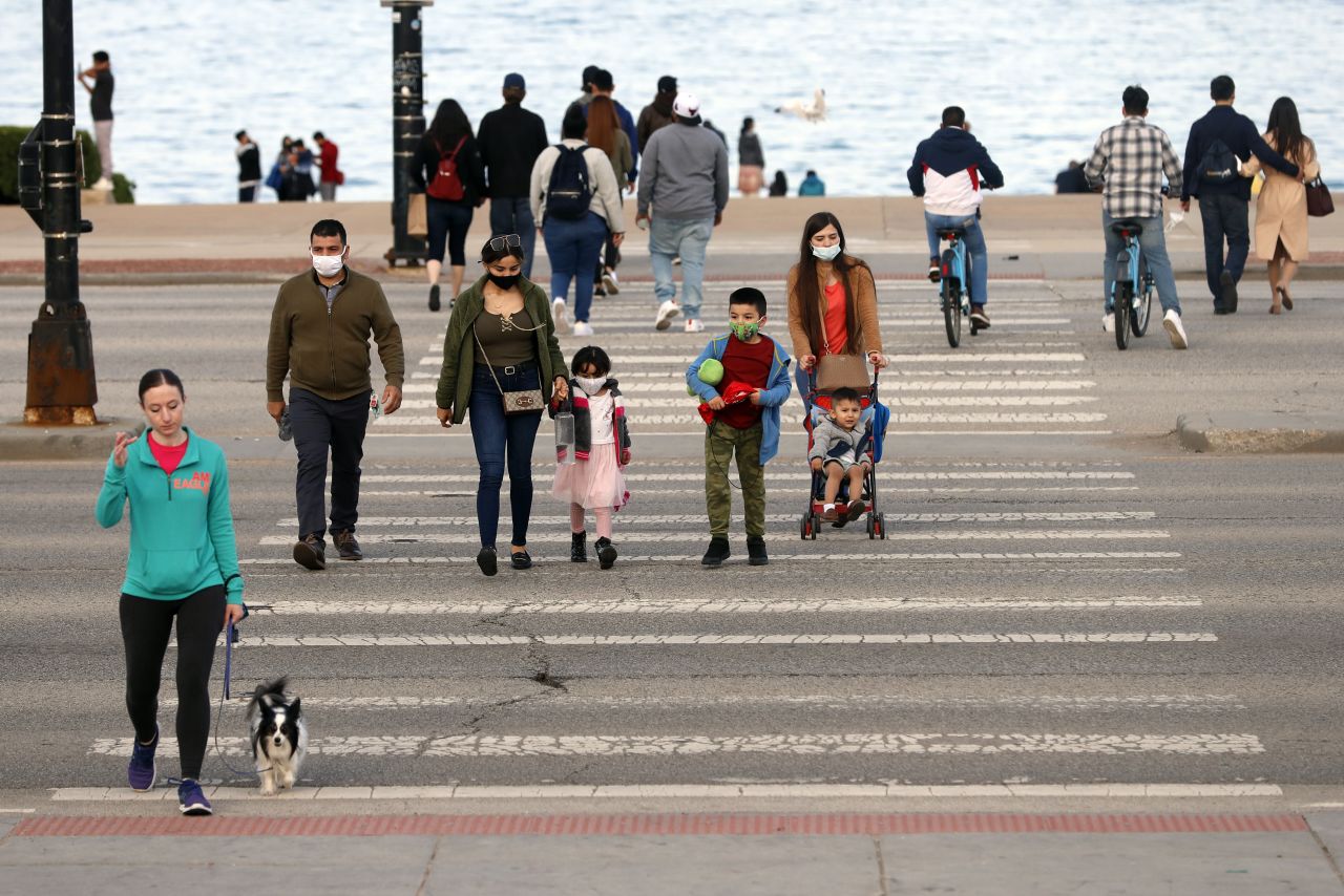 People cross the street along S. Lake Shore Drive over Memorial Day weekend, on Sunday, May 30, in Chicago.