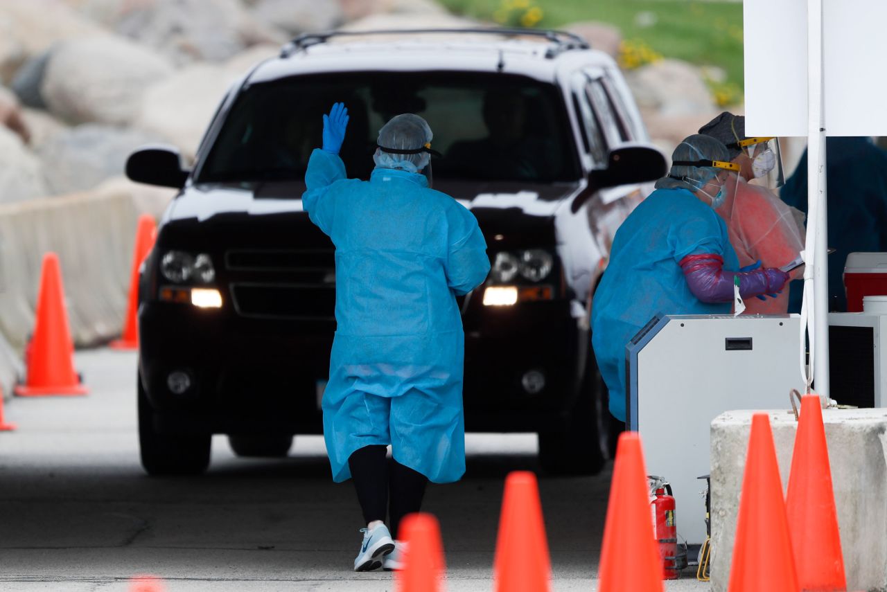 A medical worker directs a local resident at a drive-thru COVID-19 testing site in Waterloo, Iowa, on May 1. 