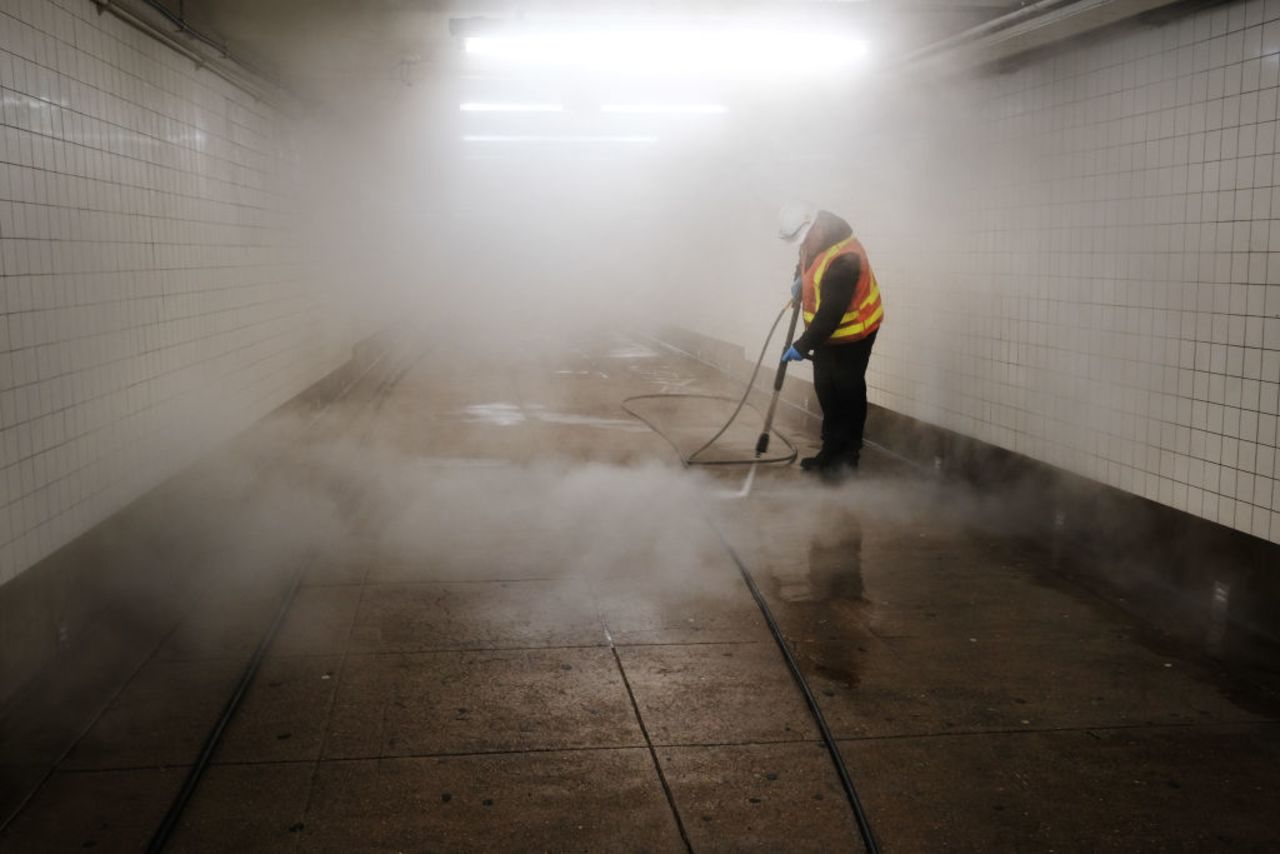 Workers clean a subway station in New York City on Wednesday.