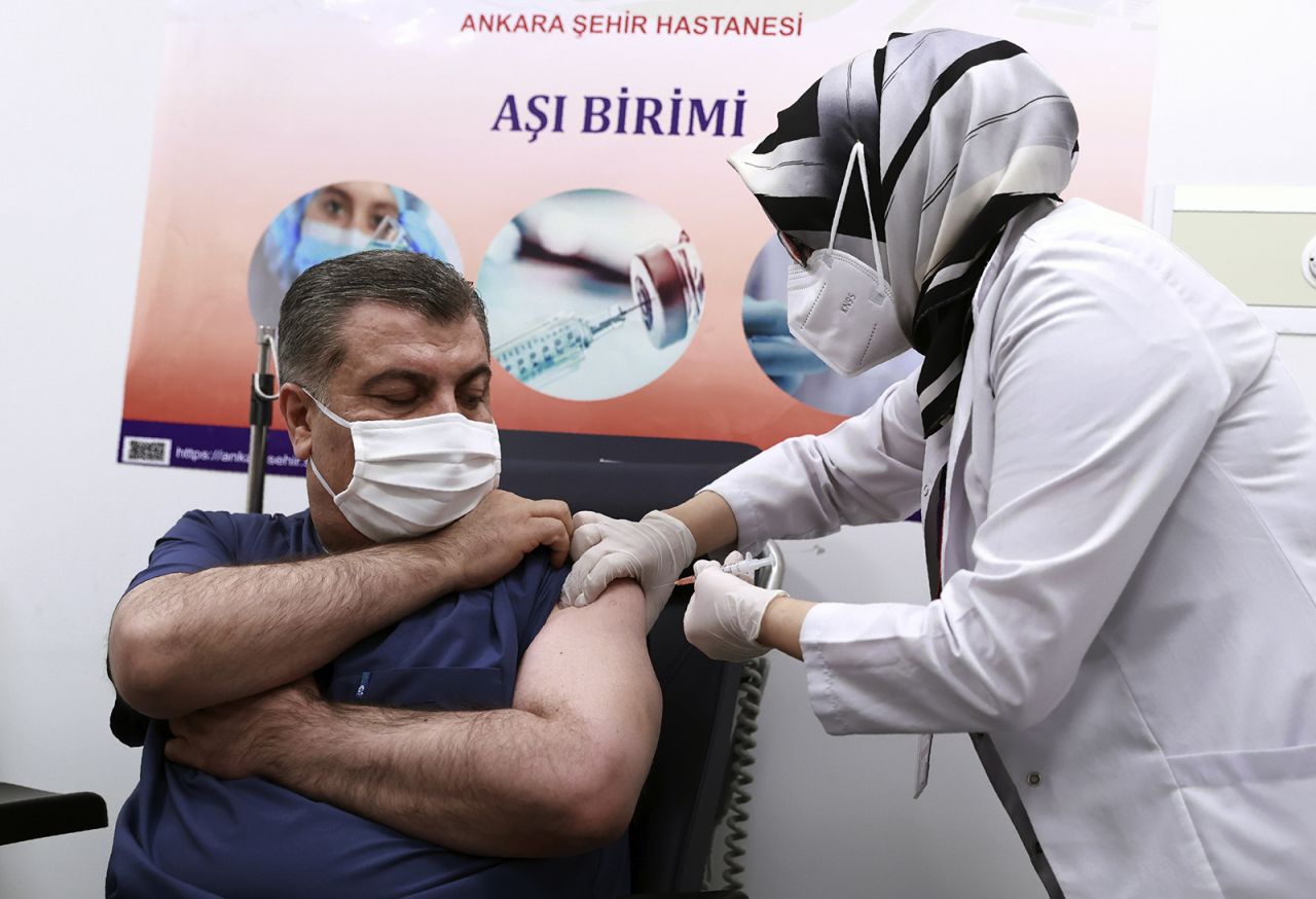 Turkey's Health Minister Fahrettin Koca receives the first shot after Turkish authorities gave the go-ahead for the emergency use of the Covid-19 vaccine produced by China's Sinovac Biotech, in Ankara, Turkey, on Wednesday, January 13.