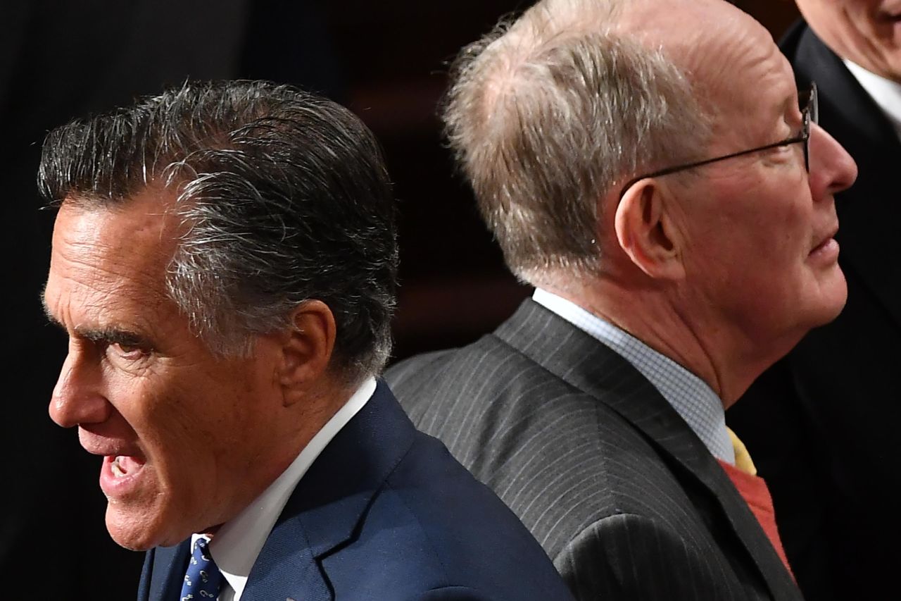 Sen. Mitt Romney and Sen. Lamar Alexander cross paths before the start of the State Of The Union address on Tuesday.