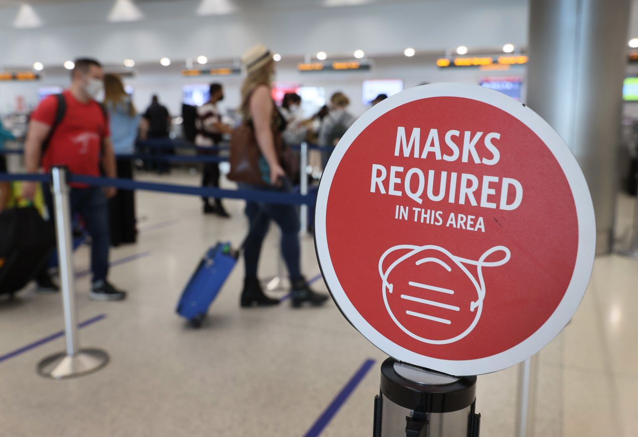 A sign is seen as travelers prepare to check-in for their flights at the Miami International Airport on February 1 in Miami.