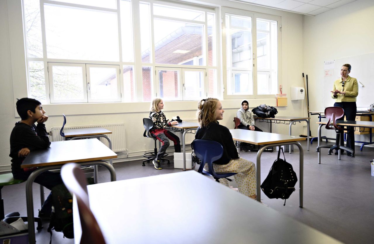 Denmark's Prime Minister Mette Frederiksen, right, speaks to pupils during the reopening of Lykkebo School in Copenhagen, on April 1.