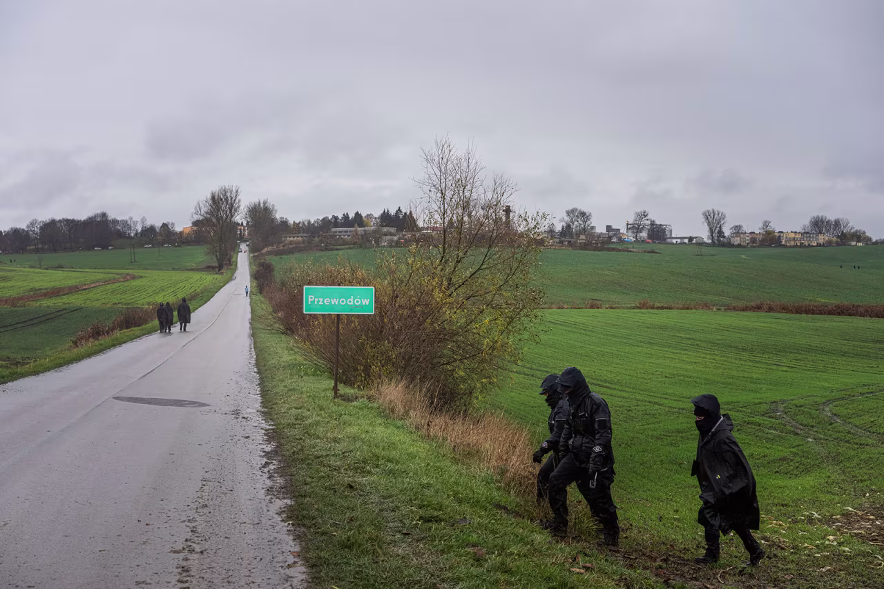 Polish police officers search for missile wreckage in a field in Przewodow, Poland, on November 16.