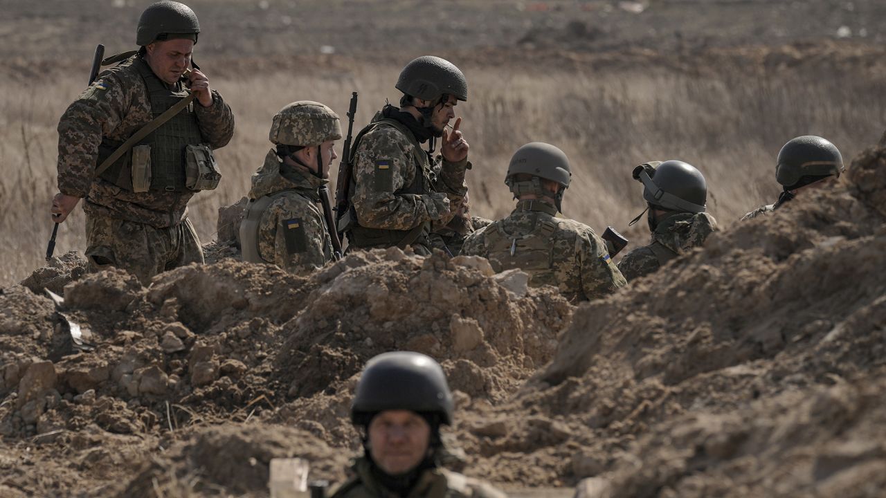 Ukrainian servicemen stand in trenches at a position north of the capital Kyiv, Ukraine, Tuesday, March 29.