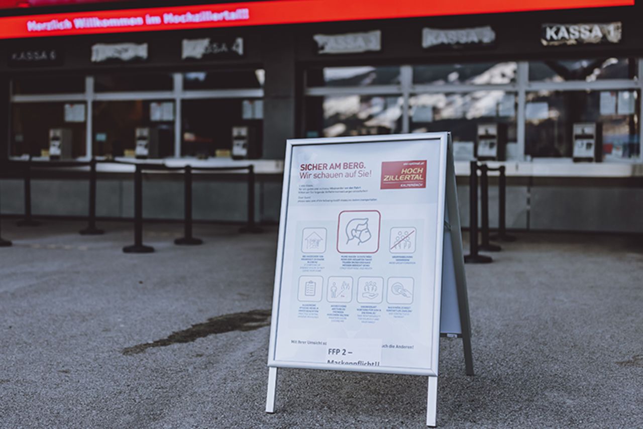 A board with hygiene instructions is pictured at the valley station of the Hochzillertal cable car in Kaltenbach in Tyrol, Austria on February 4, 2021