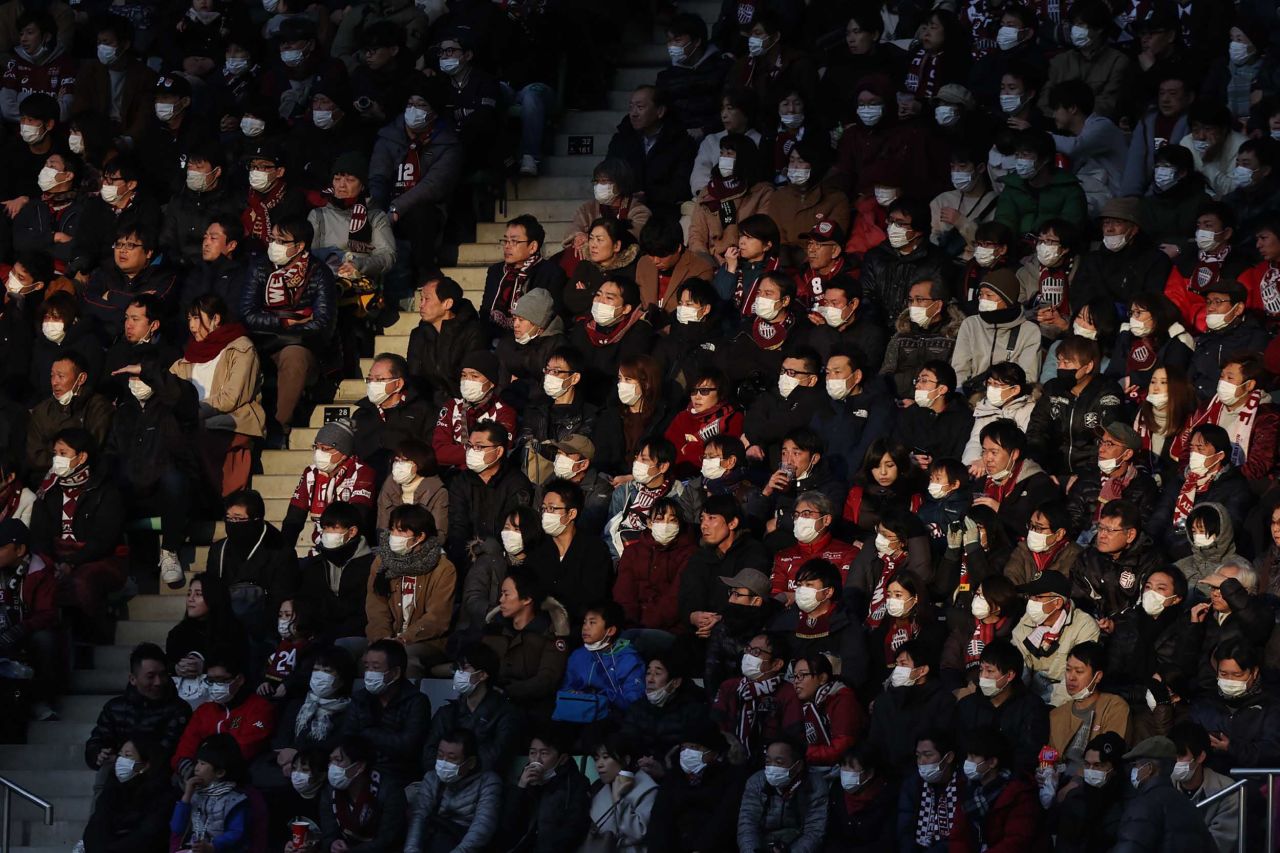 Spectators wearing face masks watch a J League soccer game in Kobe, Japan, on Sunday.