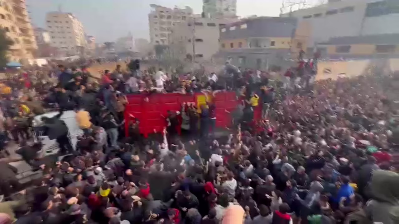 Desperate civilians swarm relief aid convoy for food on Thursday in Gaza.