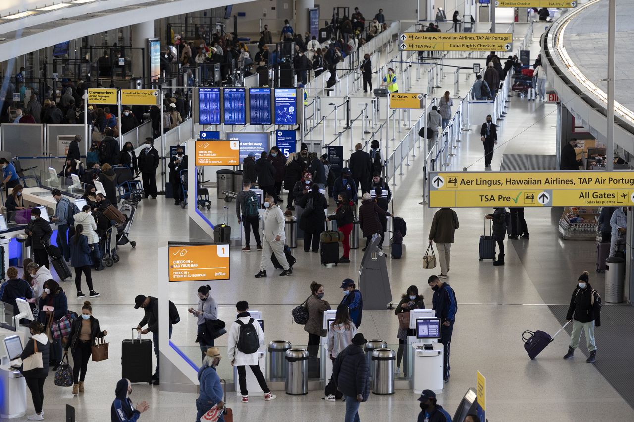 Travellers walk through Terminal 4 at John F. Kennedy International Airport (JFK) in New York, U.S., on Wednesday, November 24, 2021.?