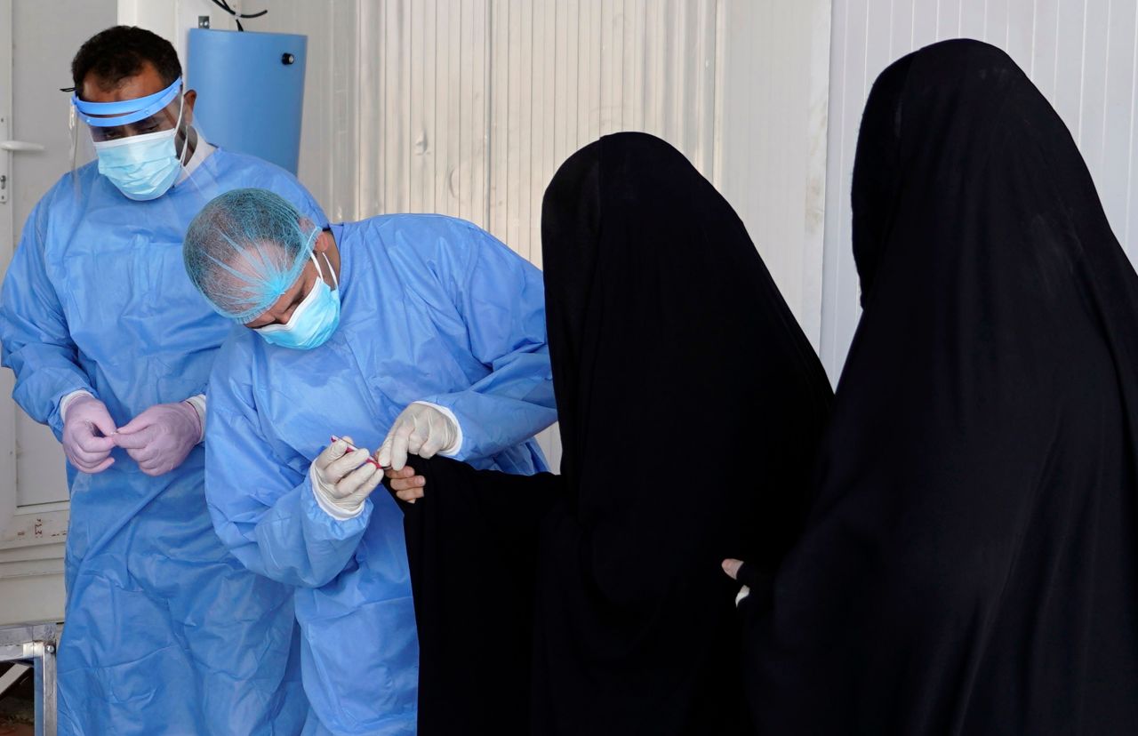 A health worker in Najaf, Iraq, administers a Covid-19 test on July 15.