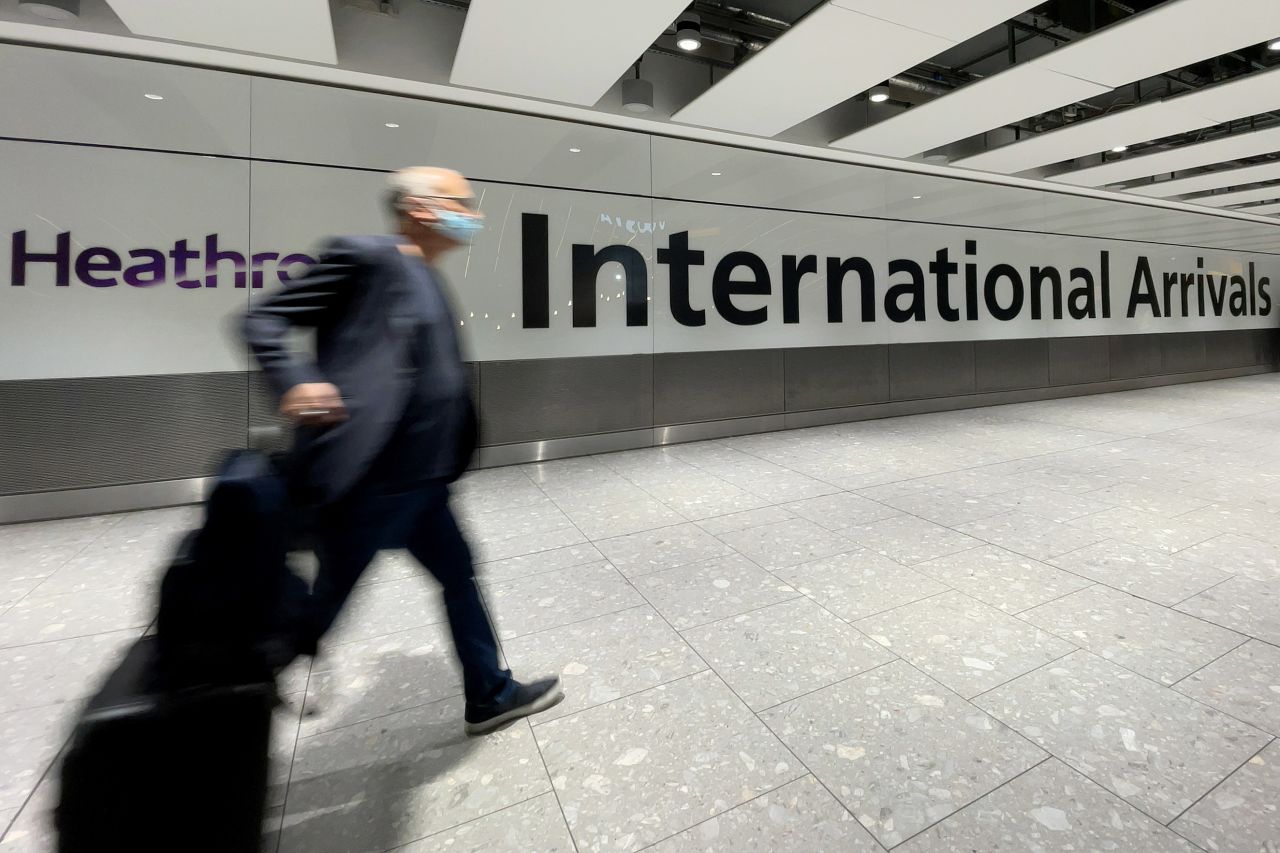 A passenger walks through the arrivals area at Heathrow Airport on November 26 in London. 