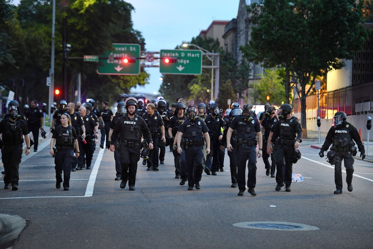 Police officers move down East Monroe Street toward Main Street in Jacksonville, Florida, on May 30.