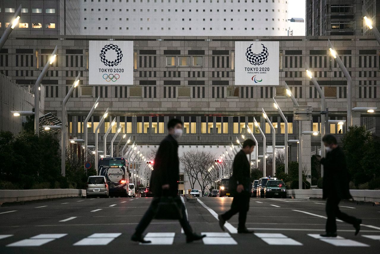 People walk across a pedestrian crossing near the Tokyo Metropolitan Government building in Tokyo on March 3.