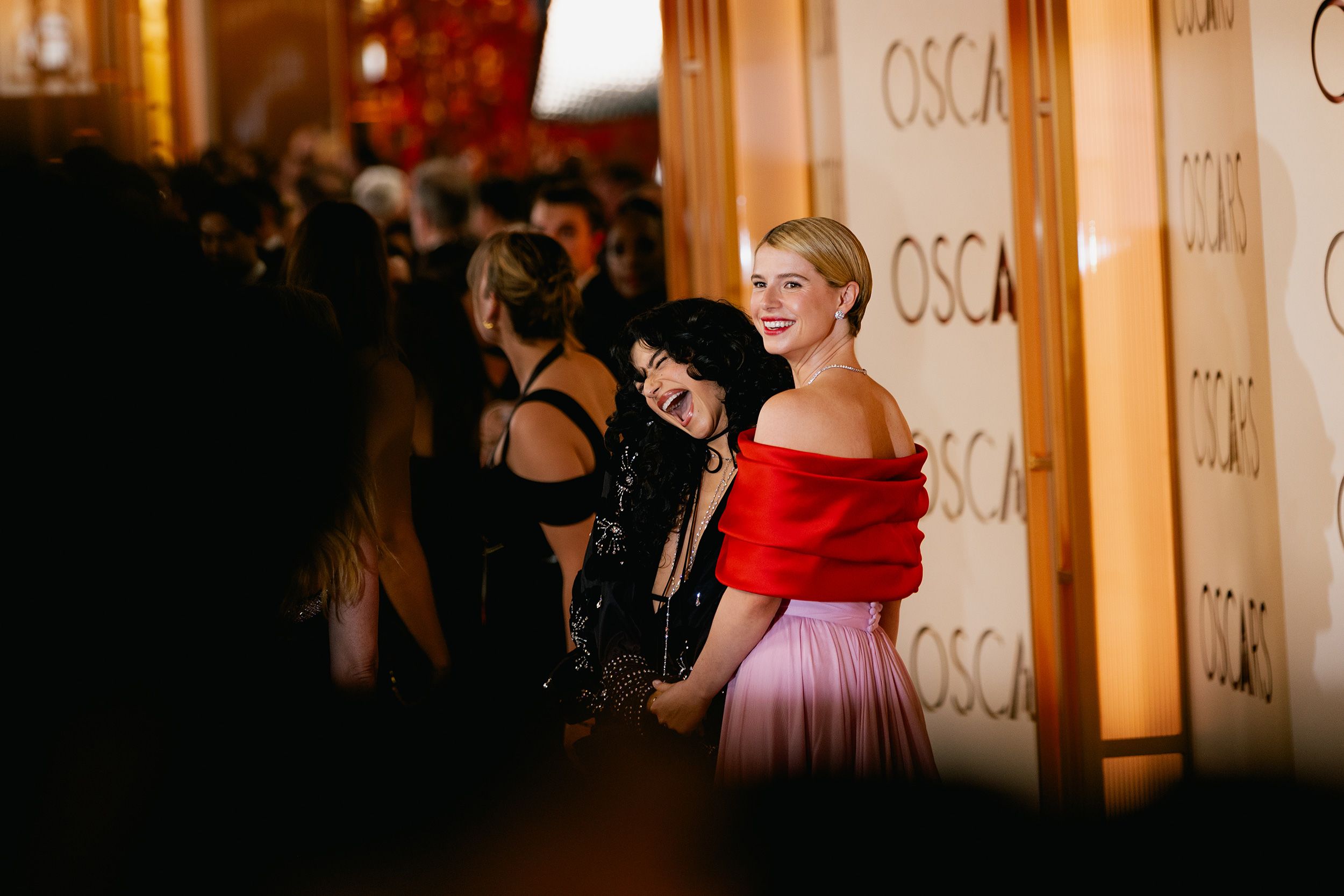 Odessa A’zion, in Valentino, poses with Jessie Buckley who wore a pink Chanel bustier dress with a red satin stole. Buckley went on to win best actress.