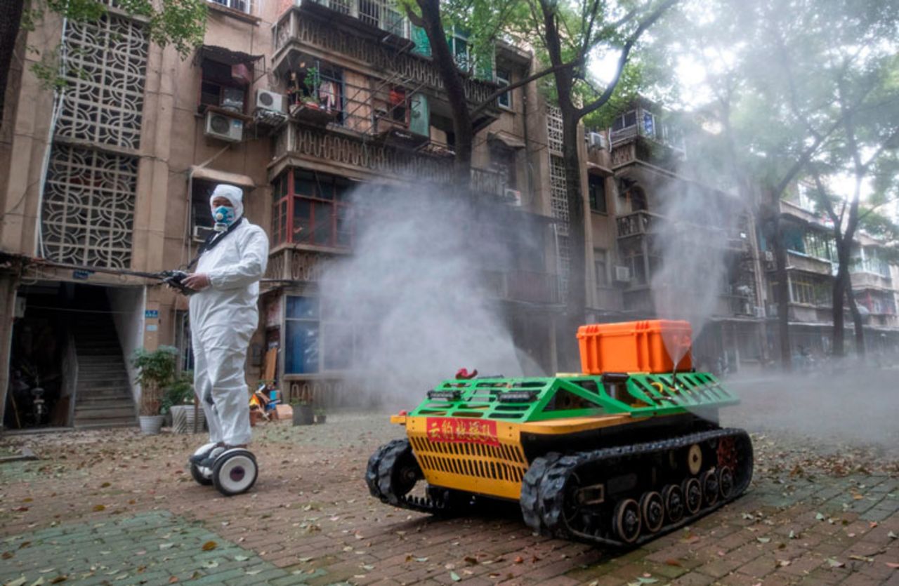 A volunteer operates a remote controlled disinfection robot to disinfect a residental area amid the coronavirus outbreak in Wuhan in China's central Hubei province on March 16.