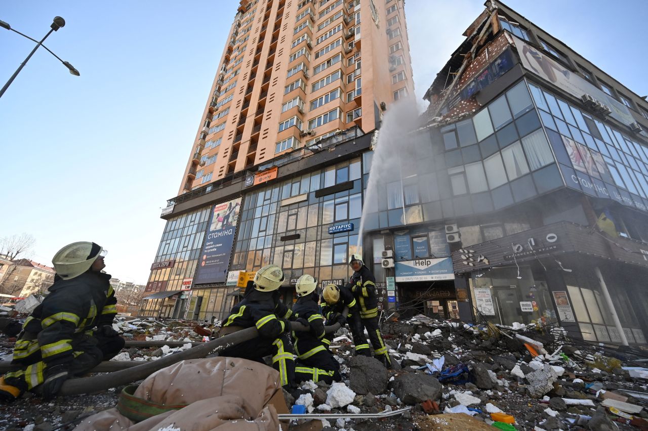 Firefighters extinguish a fire in a high-rise apartment block which was hit by recent shelling in Kyiv, Ukraine, on February 26.