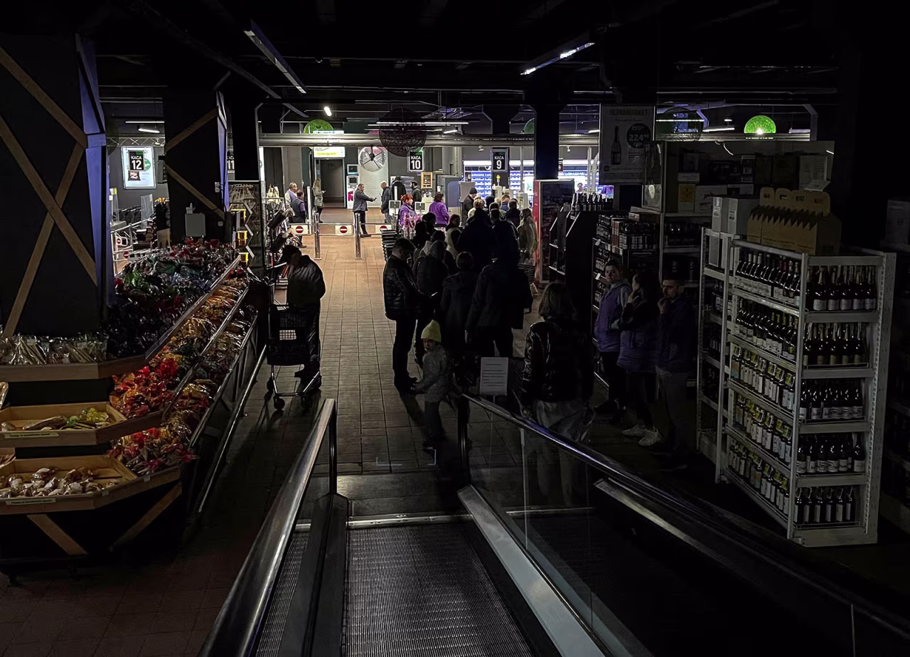 People visit a supermarket without electricity after a Russian missile attack in Kyiv, Ukraine, on October 22. 