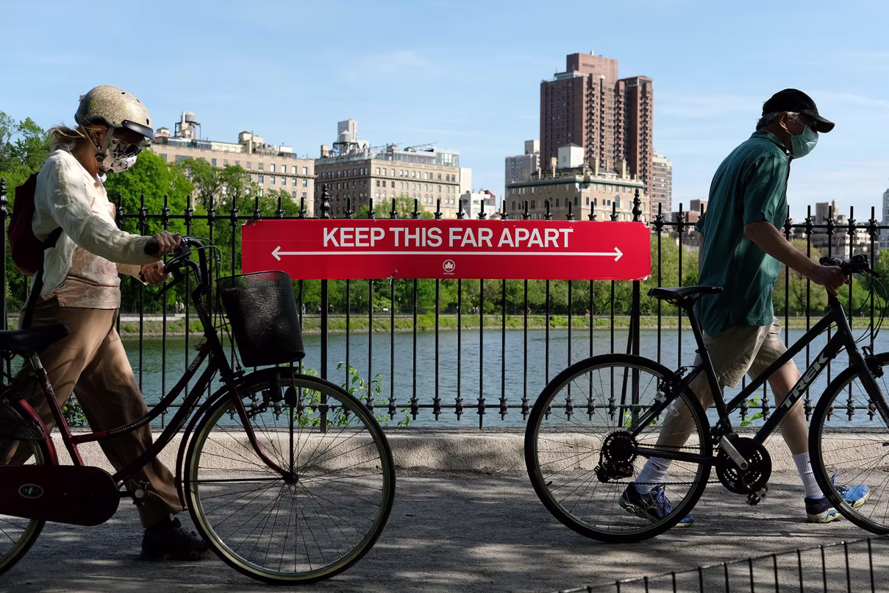 A sign in New York's Central Park encourages people keep a distance of at least six feet apart.