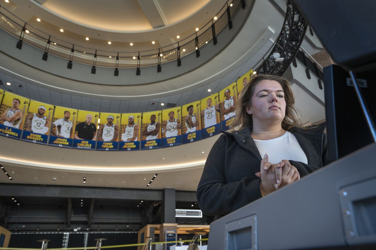 Rachel Cook waits for her ballot to be counted after voting on Election Day, Tuesday at the Gainbridge Fieldhouse, an indoor arena and home of the Indiana Pacers, in Indianapolis.