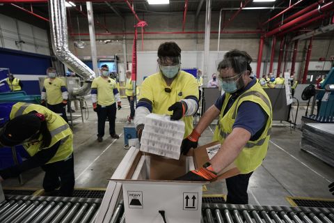 Boxes containing the Pfizer-BioNTech Covid-19 vaccine are prepared to be shipped at the Pfizer Global Supply Kalamazoo manufacturing plant on December 13, 2020 in Portage, Michigan.