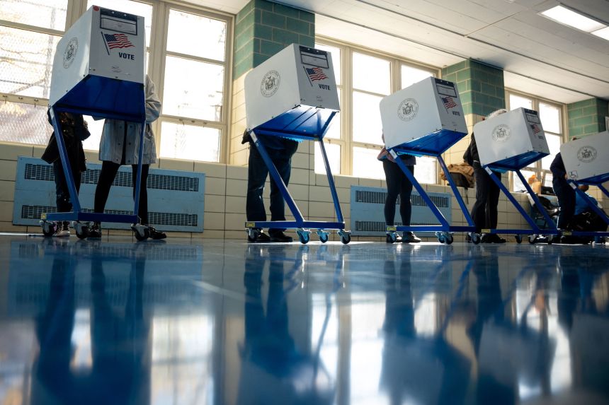 Voters fill out their ballots at a polling site in New York on Tuesday.
