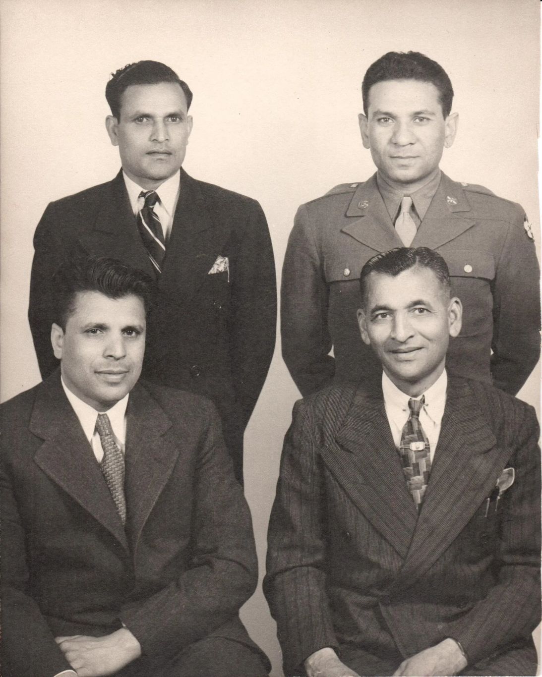Kanji Manchhu Desai, bottom right, is pictured beside friends who also helped lay the foundation for Indian immigrants in the hotel industry, according to Doshi's research.