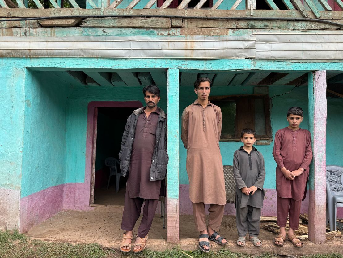 Malik Farouk's sons stand outside their home in Sharjiwal village, in Pakistani-administered Kashmir.