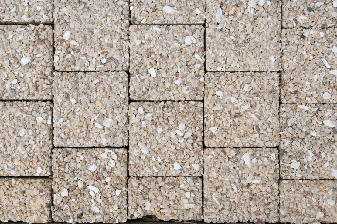 An experimental sidewalk in the Olympic village was built with seashells, which are supposed to absorb water that evaporates in the heat to keep passers-by cool.