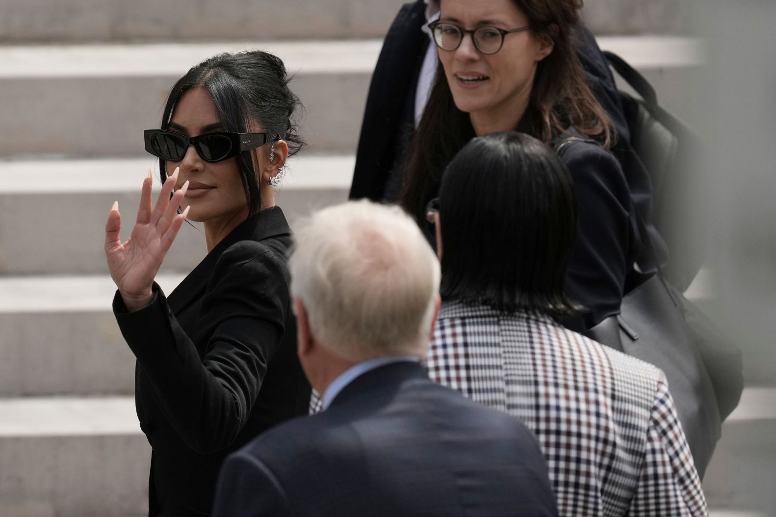 Kim Kardashian, left, walks up the steps of a Paris courthouse on Tuesday, May 13. <a href="index.php?page=&url=https%3A%2F%2Fwww.cnn.com%2F2025%2F05%2F13%2Fentertainment%2Fkim-kardashian-paris-burglary-trial-intl">Kardashian testified</a> in the trial of nine men and one woman who are accused of tying her up and robbing her at gunpoint nearly nine years ago.