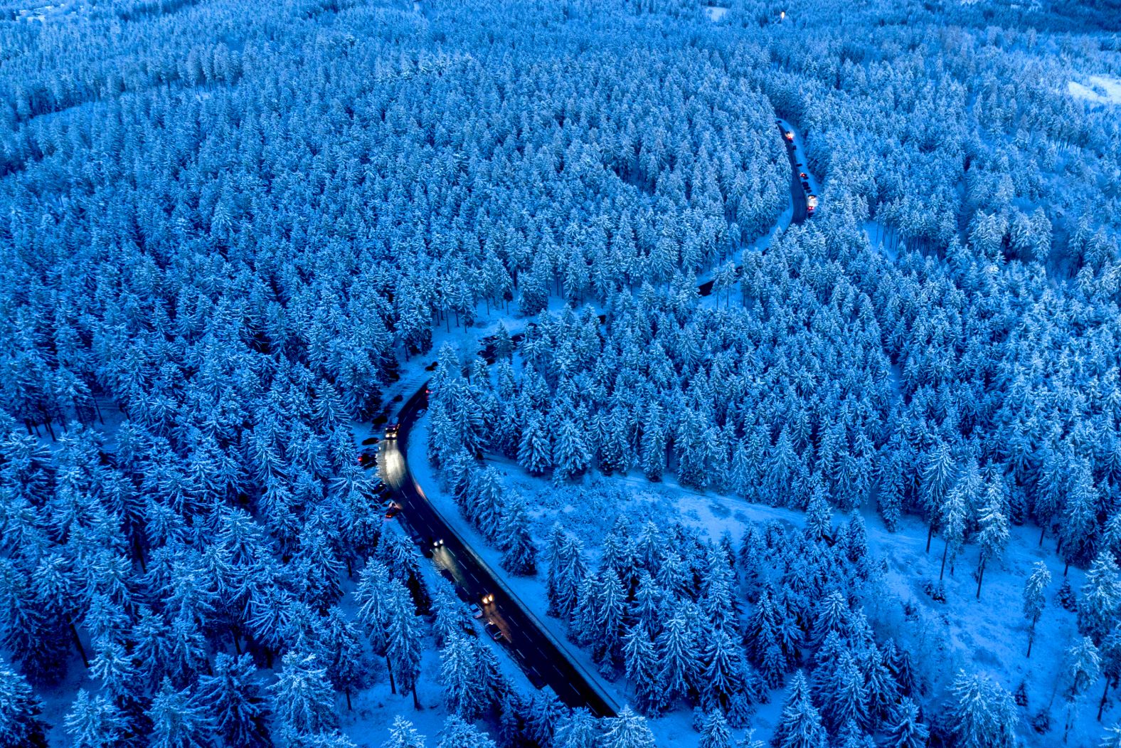 Cars drive to the top of the Feldberg mountain near Frankfurt, Germany, on Thursday, January 2.