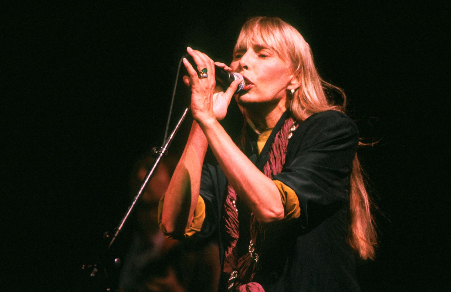 Mitchell performs at The Wall concert in Berlin. The 1990 event was organized by Pink Floyd's Roger Waters at the site where the Berlin Wall was torn down the year before.