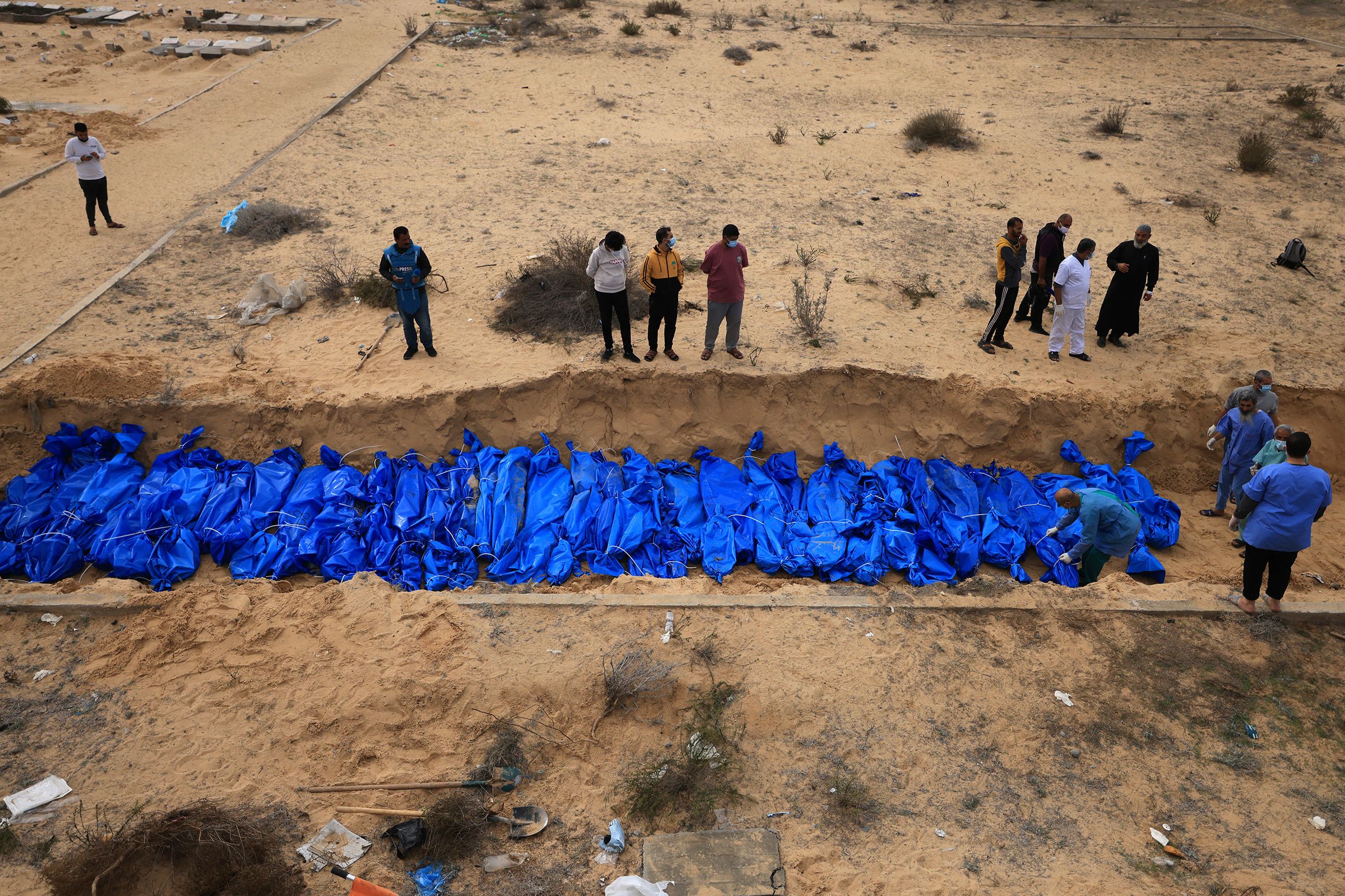 Palestinians bury bodies in a mass grave in the Khan Younis cemetery in southern Gaza on November 22.