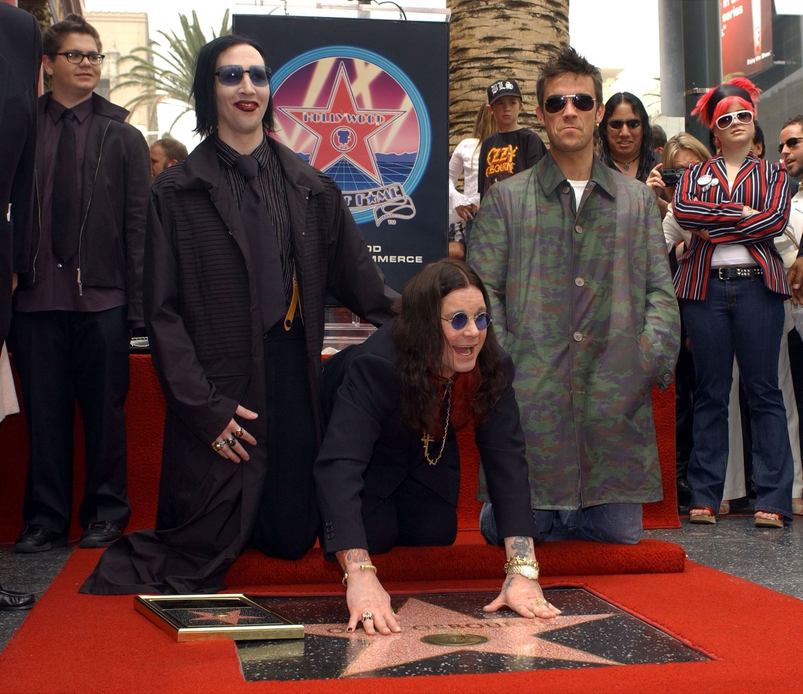 Osbourne is joined by Marilyn Manson, left, and Robbie Williams as he receives a star on the Hollywood Walk of Fame in 2002.