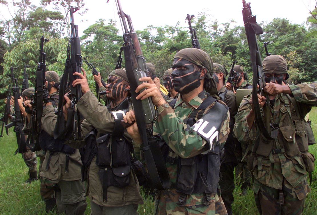 In this file photo from May 2000, members of United Self-Defense Forces (AUC) brandish their weapons during a training session in a rural area of Puerto Asis, Putumayo province southern of Colombia.