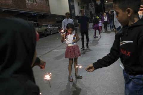 Children play with sparklers in Caracas, Venezuela.