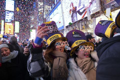 People celebrate as confetti falls in New York's Times Square.