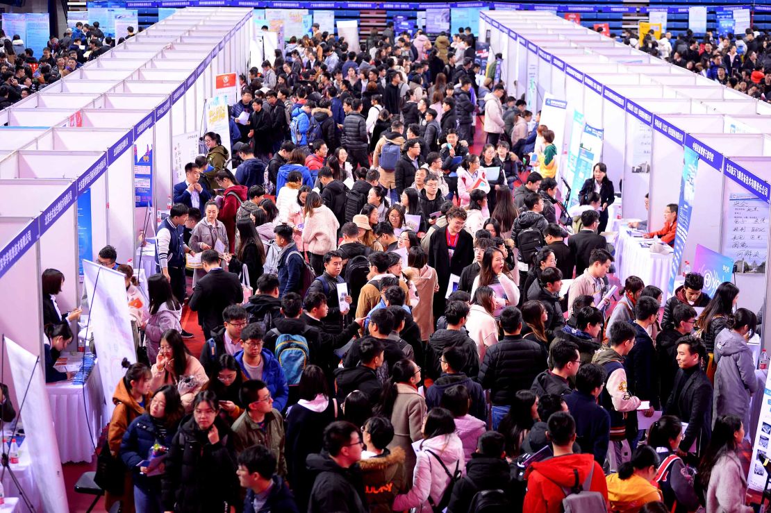 Job hunters crowd at a job fair for university graduates at Northeastern University on March 21, 2019 in Shenyang, Liaoning Province of China.