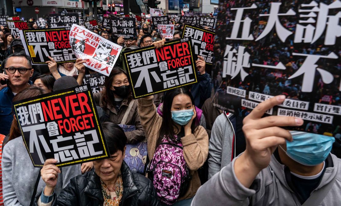 Pro-democracy supporters hold placards and shout slogans as they take part in a march during a rally on New Years Day on January 1, 2020 in Hong Kong, China. 