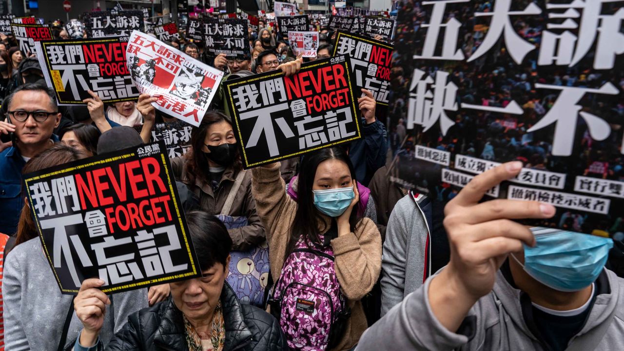 Pro-democracy supporters hold placards and shout slogans as they take part in a march during a rally on New Years Day on January 1, 2020 in Hong Kong, China. 