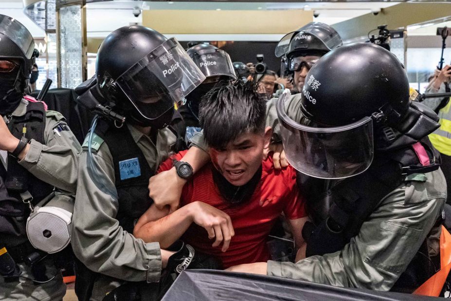 A man is detained by riot police during a demonstration in a shopping mall at Sheung Shui district on December 28.